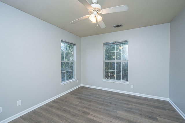 spare room with ceiling fan and dark hardwood / wood-style floors