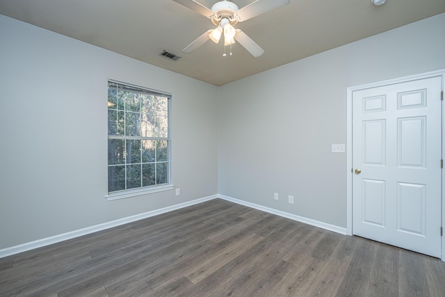 unfurnished room featuring ceiling fan and dark hardwood / wood-style floors