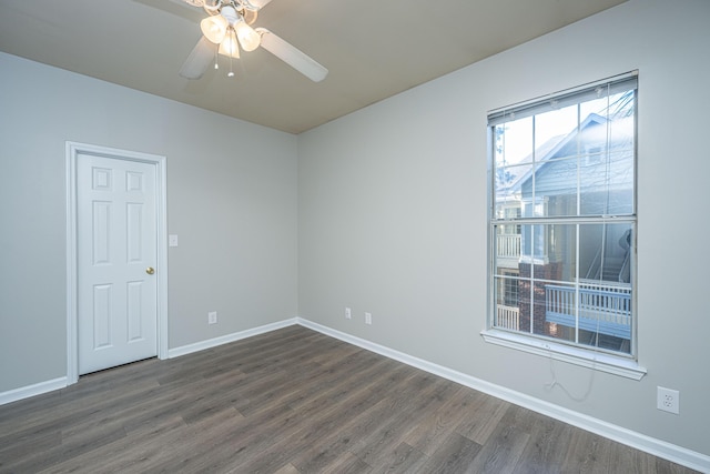 empty room featuring ceiling fan and dark hardwood / wood-style floors