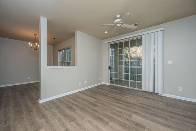 unfurnished room featuring ceiling fan with notable chandelier and wood-type flooring