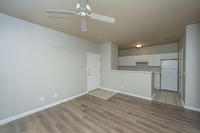 interior space with light wood-type flooring and ceiling fan