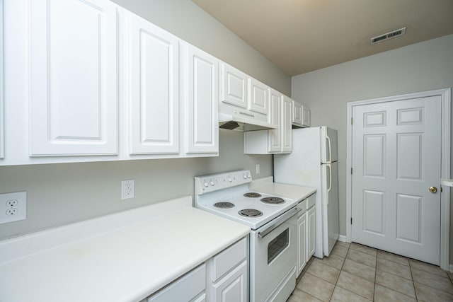 kitchen with white cabinetry, white appliances, and light tile patterned floors