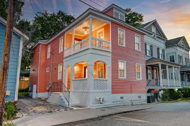 view of front of home featuring covered porch and a balcony