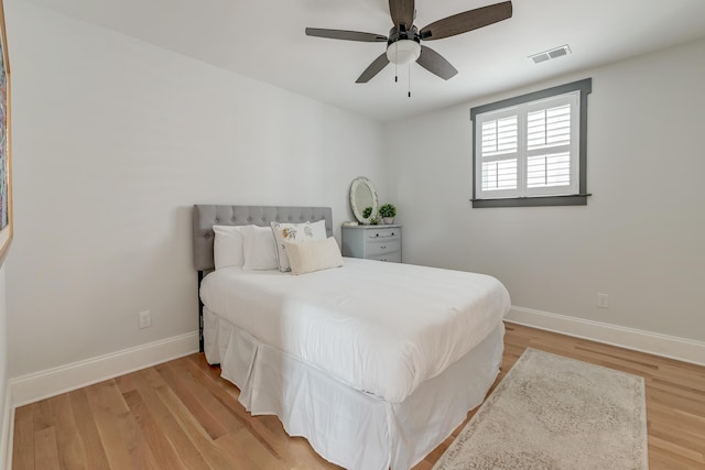bedroom with baseboards, light wood-style flooring, and visible vents