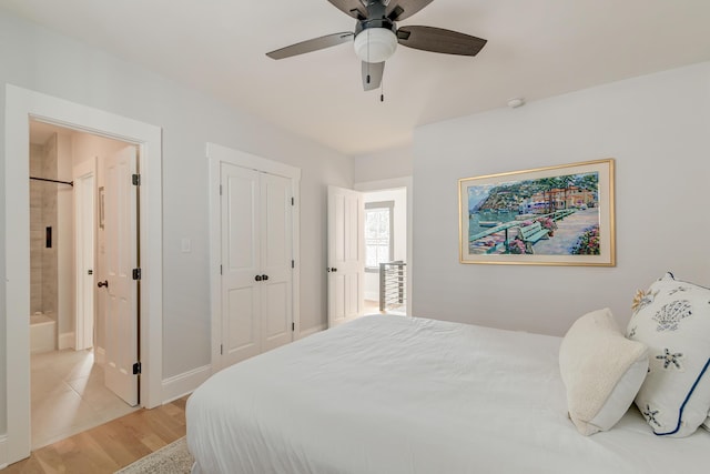 bedroom with light wood-style floors, ensuite bathroom, a closet, and ceiling fan