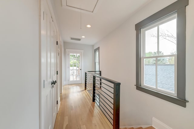 corridor featuring visible vents, attic access, recessed lighting, light wood finished floors, and an upstairs landing