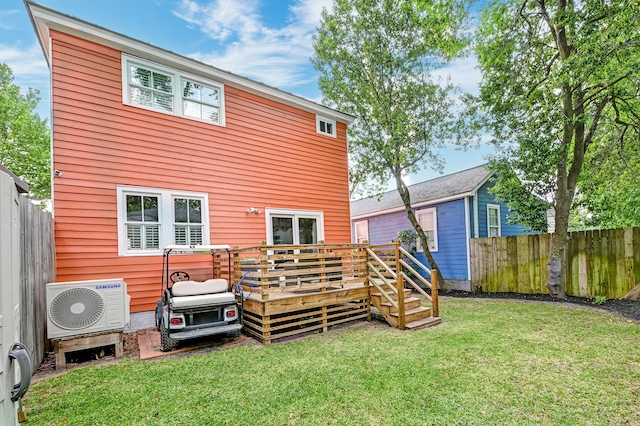 back of property featuring a lawn, ac unit, a fenced backyard, and a wooden deck