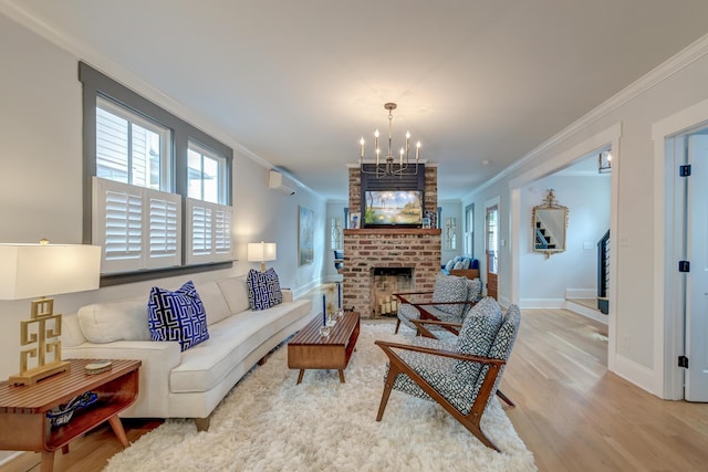 living area with an inviting chandelier, ornamental molding, a brick fireplace, and wood finished floors