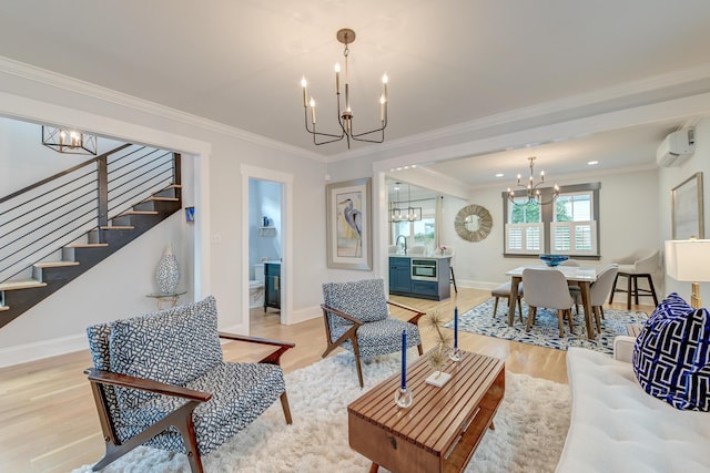 living room featuring an AC wall unit, a notable chandelier, ornamental molding, stairs, and light wood-style flooring