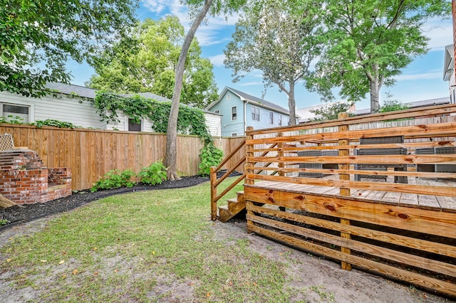 view of yard with fence and a wooden deck