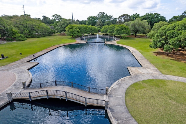 view of swimming pool with a lawn