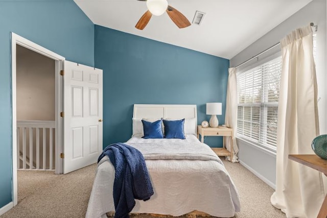 bedroom with carpet floors, visible vents, baseboards, and ceiling fan