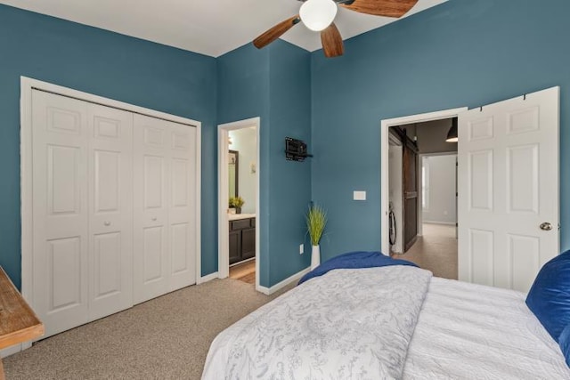 bedroom with baseboards, connected bathroom, a ceiling fan, carpet, and a closet