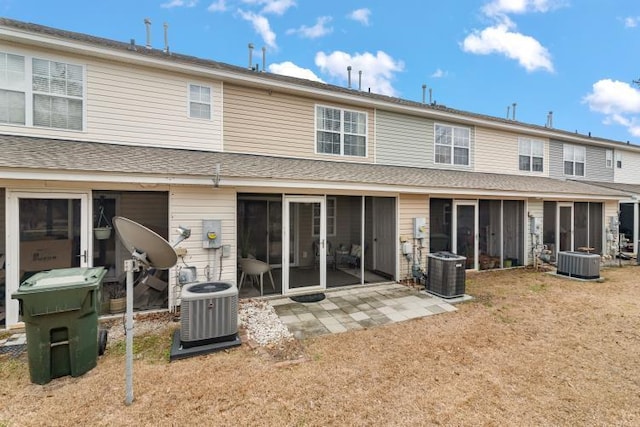 rear view of house with a patio area, central AC unit, and a sunroom