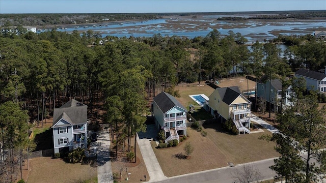 aerial view featuring a water view and a wooded view