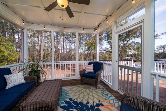 sunroom featuring a ceiling fan and rail lighting