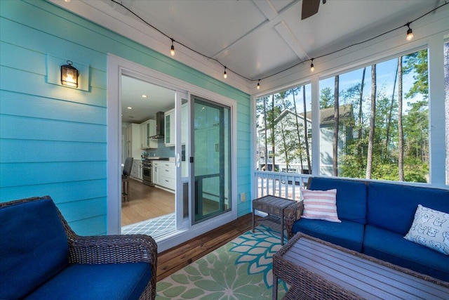 sunroom featuring a wealth of natural light and rail lighting