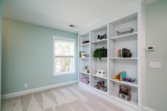 rec room featuring carpet, built in features, visible vents, and baseboards