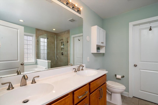 bathroom with a shower stall, visible vents, a sink, and tile patterned floors