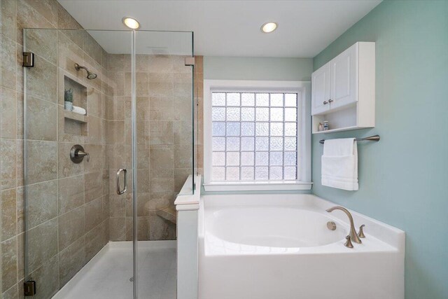 bathroom featuring recessed lighting, a shower stall, and a bath