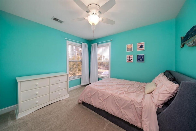 carpeted bedroom with ceiling fan, visible vents, and baseboards