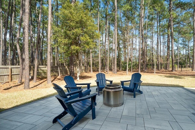 view of patio featuring a fire pit and fence