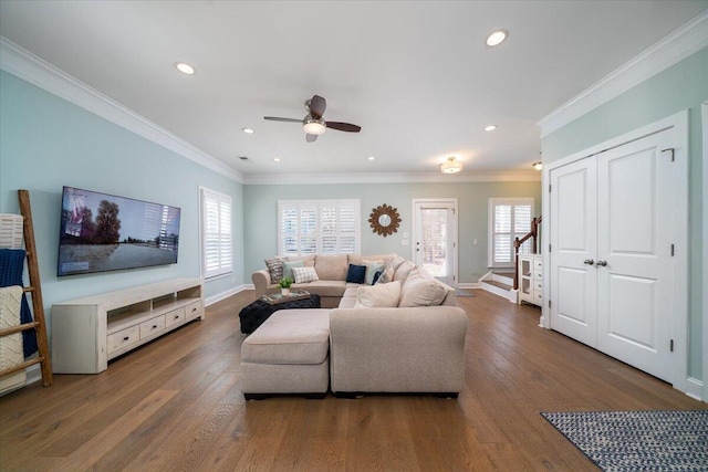 living room with ornamental molding, a wealth of natural light, wood-type flooring, and baseboards