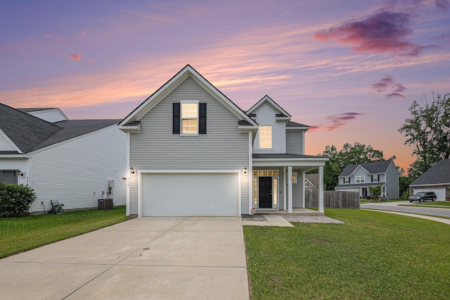 traditional home with concrete driveway, a garage, central AC unit, and covered porch