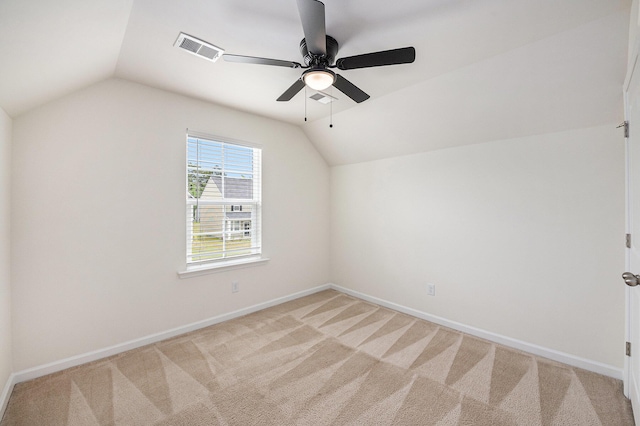 additional living space featuring vaulted ceiling, ceiling fan, light colored carpet, and baseboards