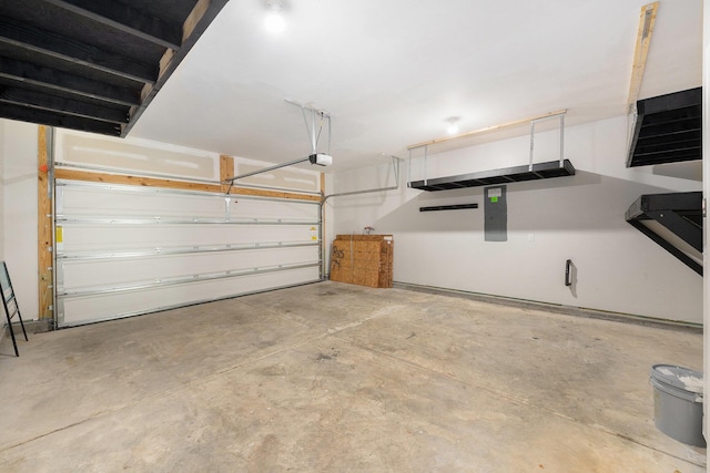 garage with a garage door opener and electric panel