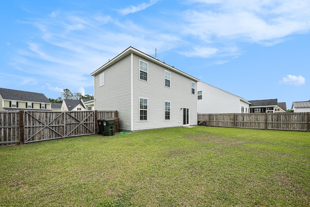 rear view of house featuring a gate