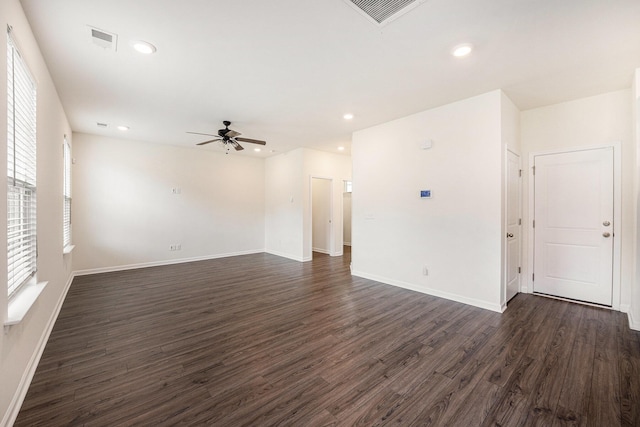spare room with dark wood-style floors, a ceiling fan, baseboards, and recessed lighting