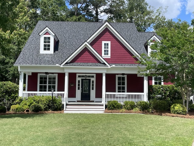 craftsman inspired home featuring a porch, a ceiling fan, and roof with shingles