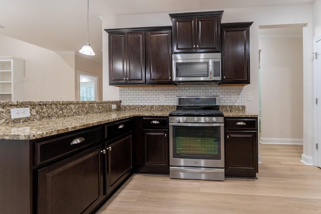kitchen with appliances with stainless steel finishes, tasteful backsplash, light wood-type flooring, light stone countertops, and baseboards