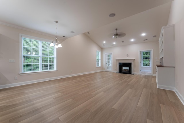 unfurnished living room with light wood-type flooring, a chandelier, a fireplace, baseboards, and ceiling fan