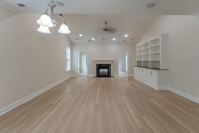 unfurnished living room featuring light wood-style floors, ceiling fan, a multi sided fireplace, a chandelier, and vaulted ceiling