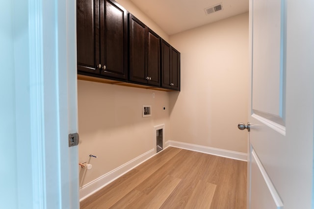 washroom featuring cabinet space, light wood-style floors, gas dryer hookup, hookup for an electric dryer, and hookup for a washing machine