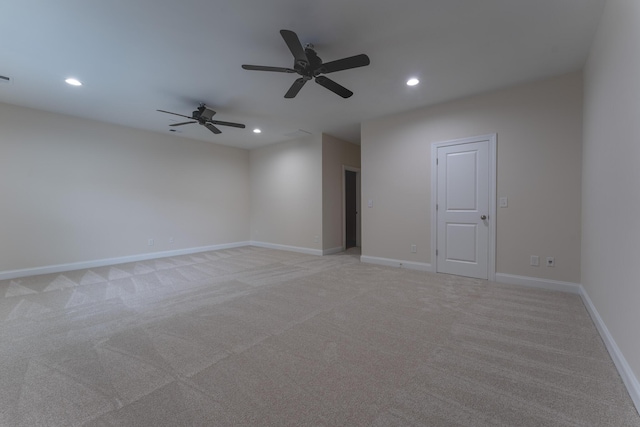 spare room with recessed lighting, a ceiling fan, light carpet, and baseboards