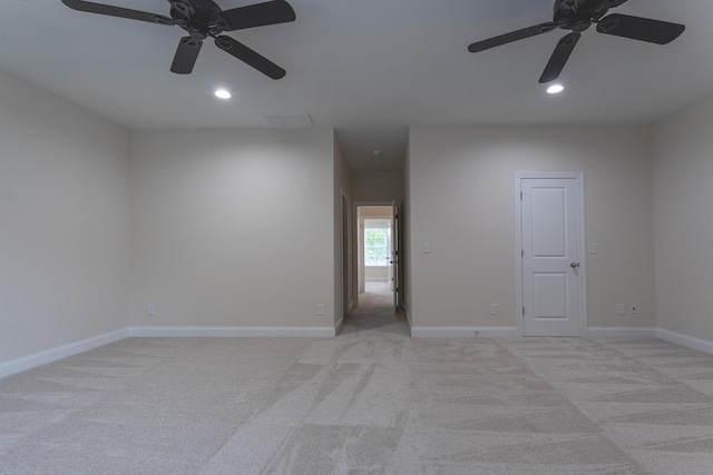 spare room featuring a ceiling fan, light carpet, recessed lighting, and baseboards