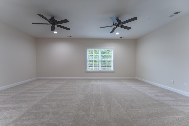 empty room with recessed lighting, light carpet, a ceiling fan, and baseboards