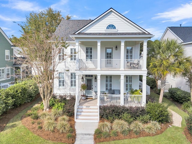 view of front of property with a balcony and a porch