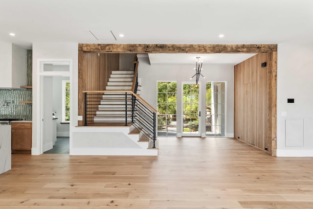 foyer entrance featuring light wood-style flooring, stairs, a chandelier, recessed lighting, and baseboards