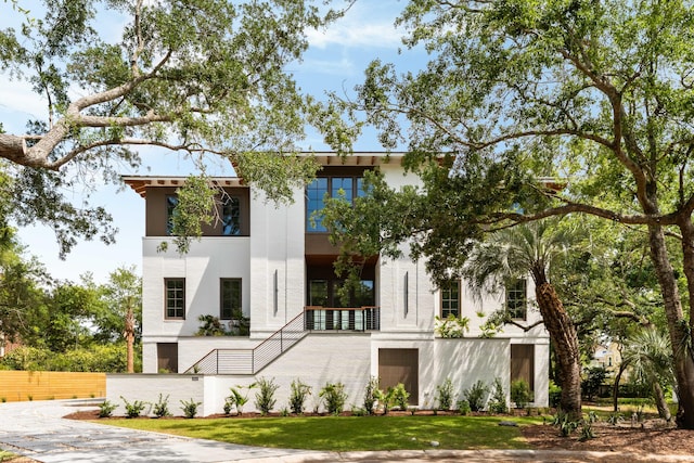 contemporary home with stucco siding and fence