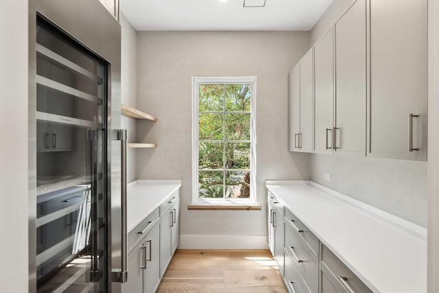 interior space with baseboards and light wood-style floors