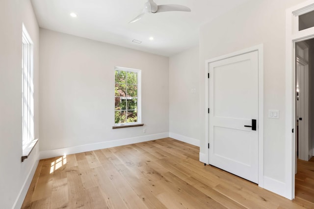 spare room featuring light wood-style floors, recessed lighting, baseboards, and ceiling fan