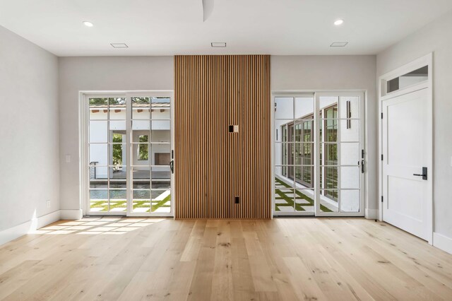 entryway with wood finished floors, recessed lighting, and baseboards