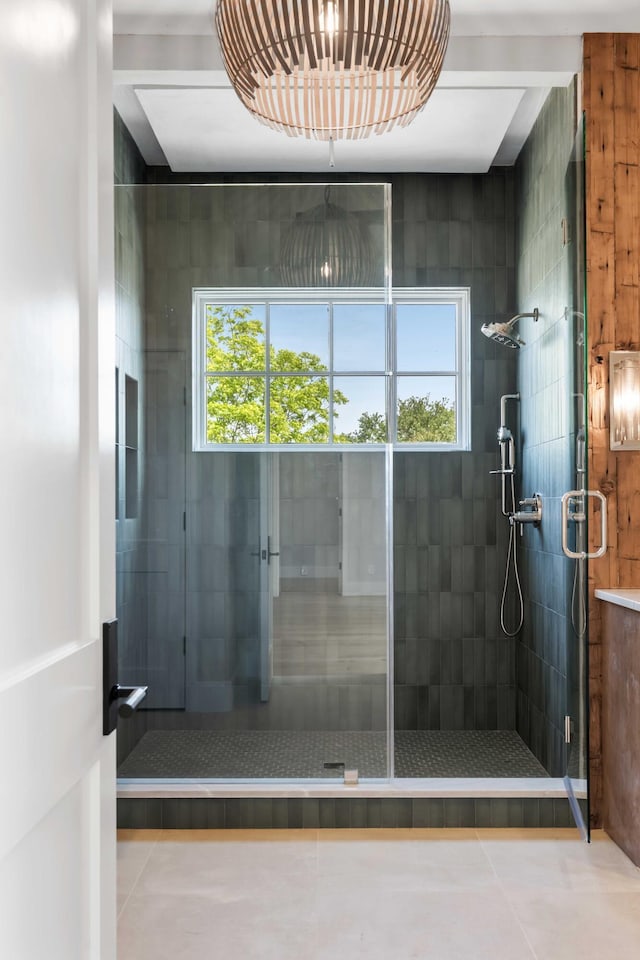 full bath featuring healthy amount of natural light, a shower stall, and tile patterned flooring
