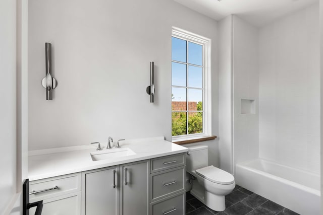 bathroom with toilet, vanity, and tile patterned flooring
