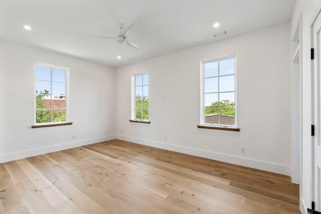 spare room with ceiling fan, baseboards, light wood finished floors, and recessed lighting