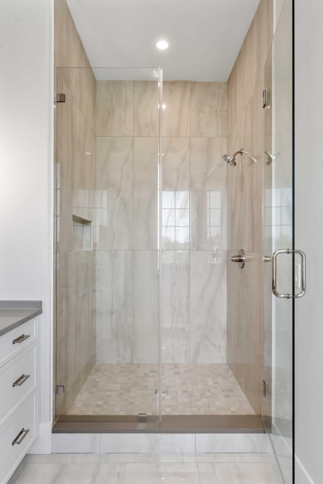 bathroom with a shower stall and recessed lighting